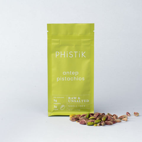Green bag of PHISTIK pistachios on a white background
